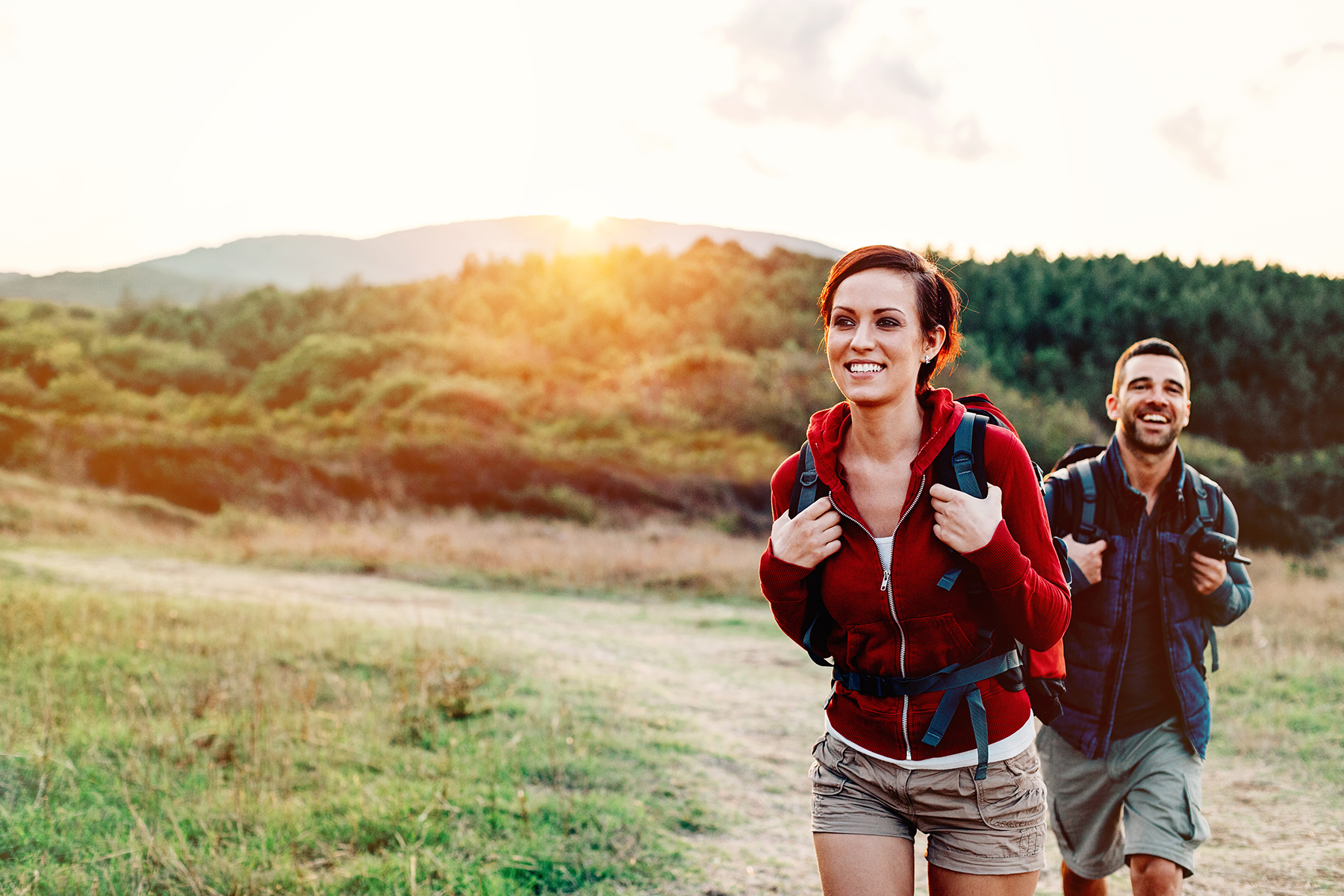 Smiling woman and man in the forest