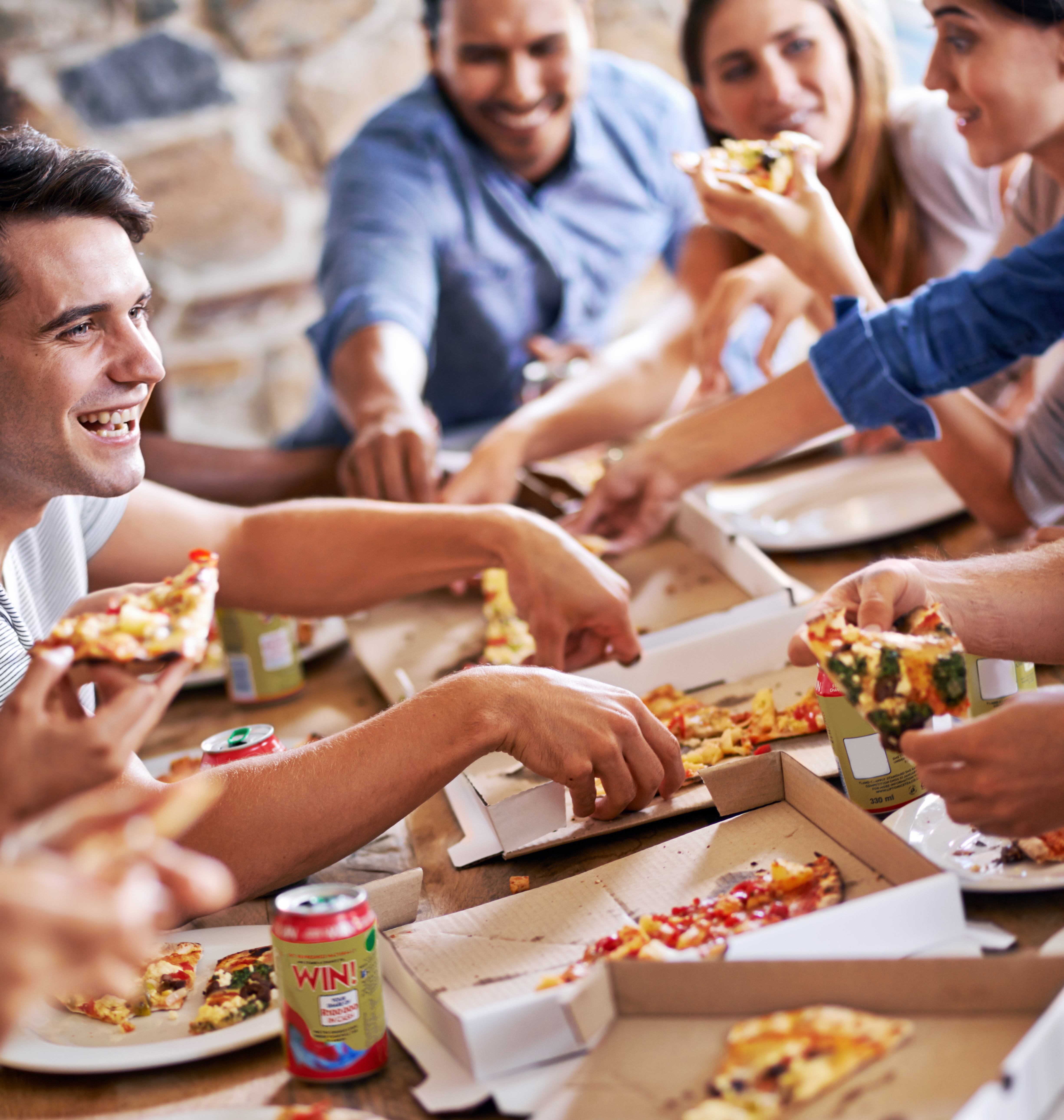 Cropped shot of a group of friends enjoying pizza together