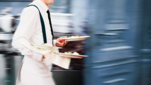 waiter serving food at a restaurant