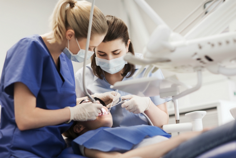 two dentists working on a patient