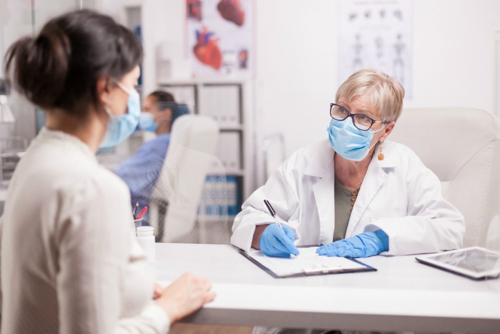 medical employee filling out customer information