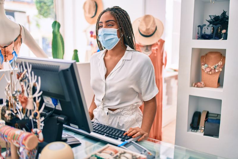 employee behind cash register wearing mask