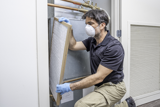 technician installing commercial air conditioning