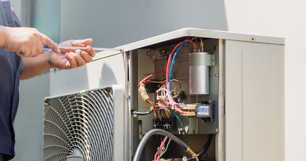 technician fixing a furnace