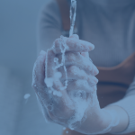 faded image of soapy hands under running water