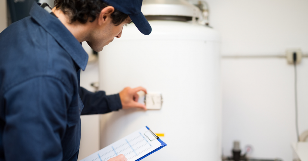 technician reviewing a water heater