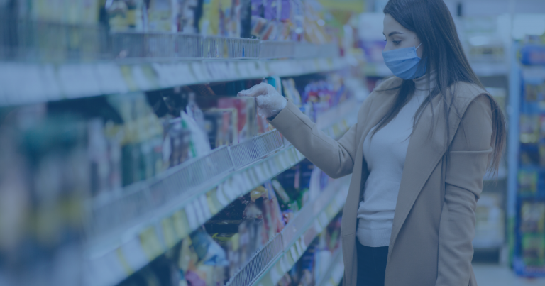 Woman wearing a mask shopping in a grocery store.